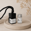 glass perfume bottle and small jar on tray
