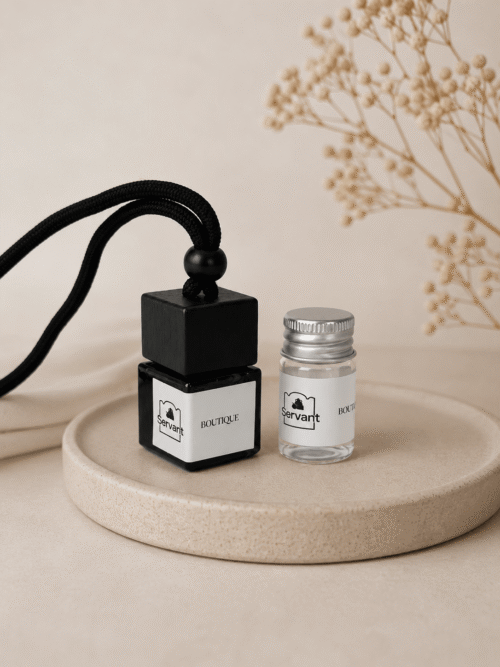 glass perfume bottle and small jar on tray
